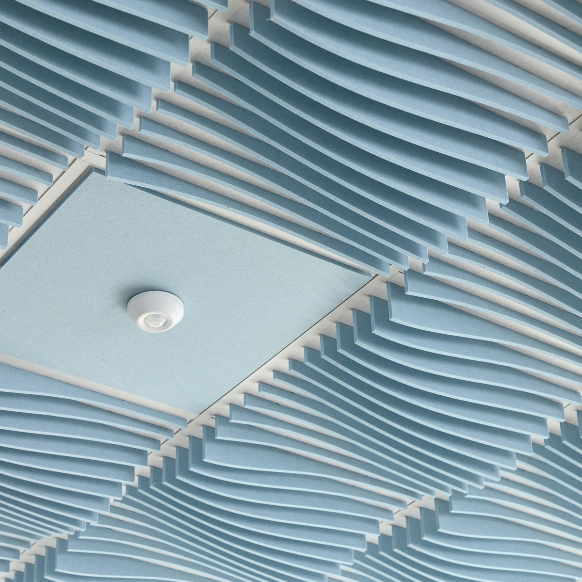Powder Blue Ripple felt drop ceiling tiles around a flat tile with a smoke detector