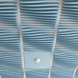 Powder Blue Ripple felt drop ceiling tiles around a smoke detector tile in a ceiling grid
