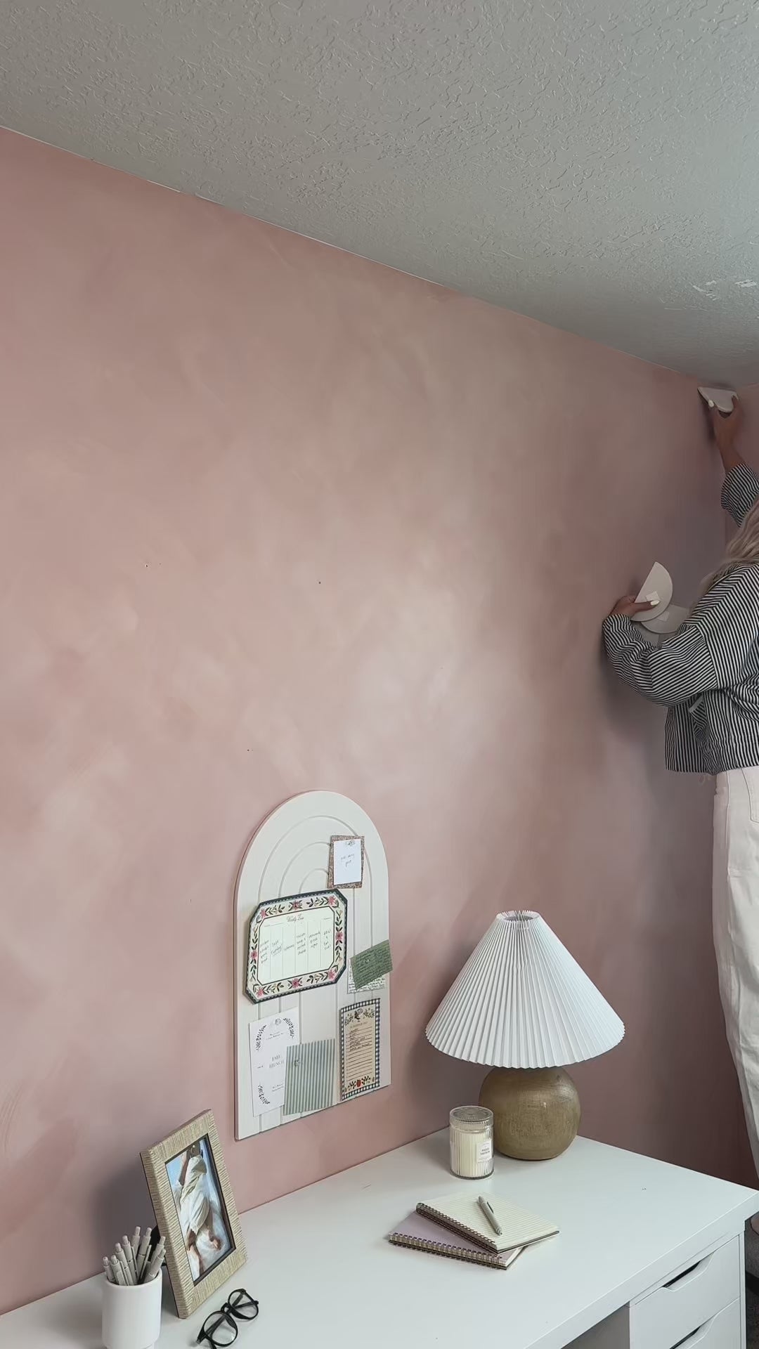 Women installing mini scallops in a pink bedroom