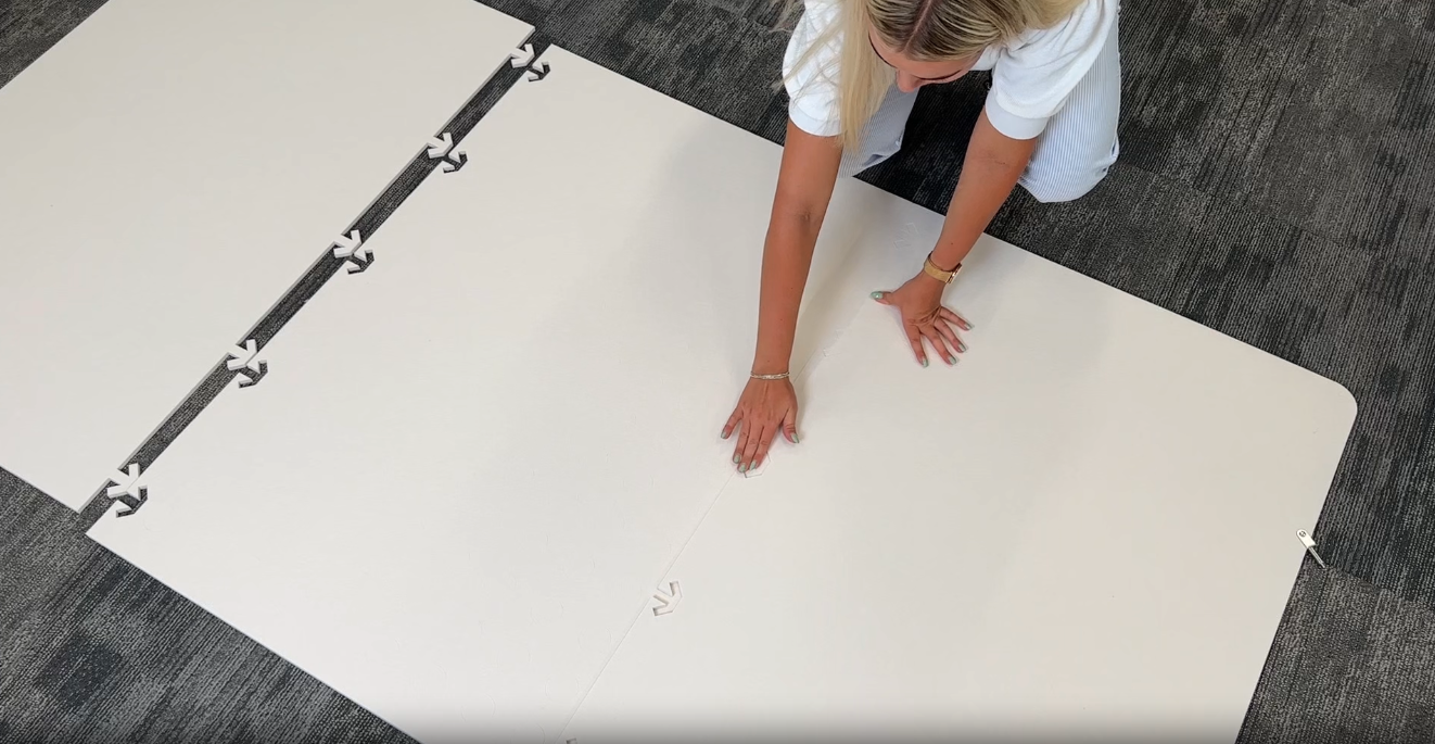 Installing modular room divider by taking it out of box and snapping pieces together. 