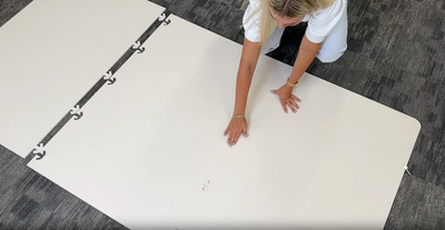 Installing modular room divider by taking it out of box and snapping pieces together. 