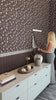 Women Installing Brown Blossom Wall Panels in a commercial waiting room. 