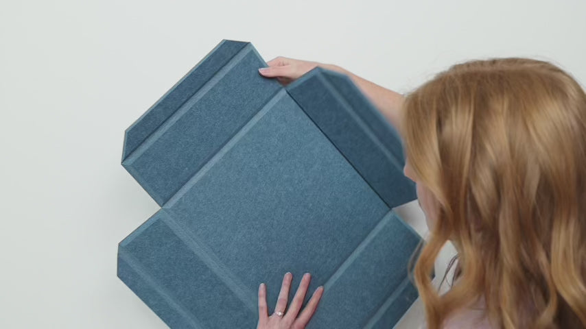 woman installing 3d felt acoustic boxes with tape, glue, and screws optionns.