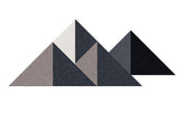 Geometric mountain sculpture with triangular peaks in shades of gray, tan, and black on white background.