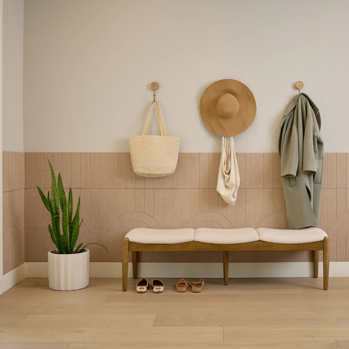 Cashmere Zen Parallel felt wainscoting in an entryway with a wood bench and wall hooks