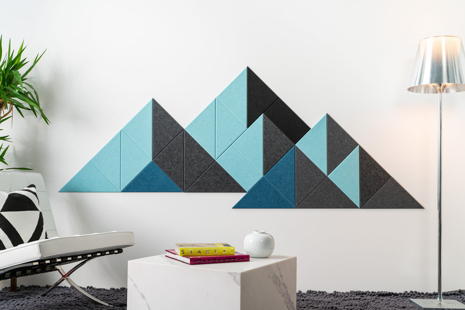A Felt Right modern geometric wall art representing a mountain range, composed of multiple triangular panels in varying shades of blue and gray, mounted on a white wall.