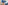 A Felt Right wall art design in shades of blue felt tiles spaced on a white wall with a woman on a couch reading.